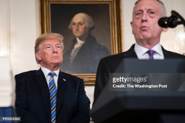 President Donald J. Trump listens to Defense Secretary Jim Mattis speak about the $1.3 trillion spending bill passed by Congress early Friday and...