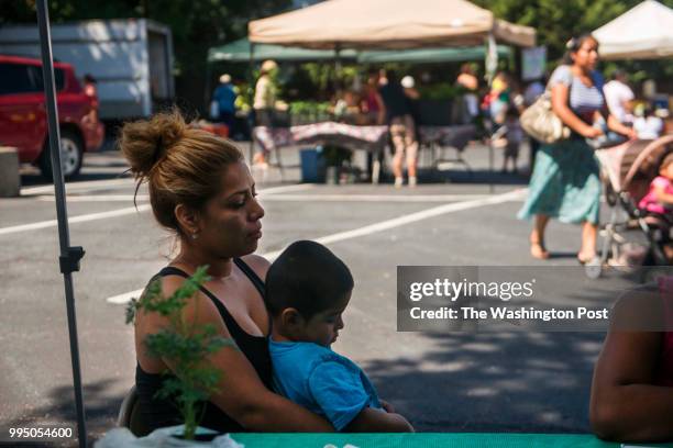 Elizabeth Perez, left, and her son Jayden Perez are assisted by SNAP Outreach Assistant, Victoria hall, not pictured, in gaining access to county...