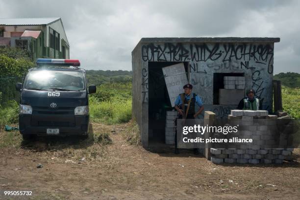 July 2018, Nicaragua, Diriamba: Two police officers stand guard. While a Catholic mission tried to get into the church, where at least nine people...