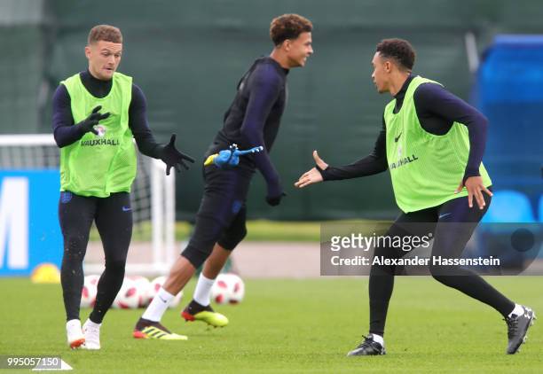 Trent Alexander-Arnold of England passes the toy chicken to Kieran Trippier of England during the England training session on July 10, 2018 in Saint...