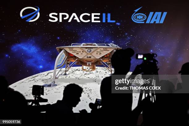 Journalists prepare to attend a press conference by Israeli Aerospace Industries space division to announce the launch of an spacecraft to the moon...