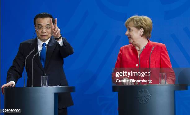 Li Keqiang, China's premier, left, gestures while speaking beside Angela Merkel, Germany's chancellor, during a news conference at the Chancellery...