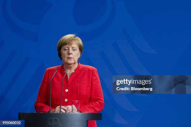 Angela Merkel, Germany's chancellor, closes her eyes during a news conference at the Chancellery building in Berlin, Germany, on Monday, July 9,...