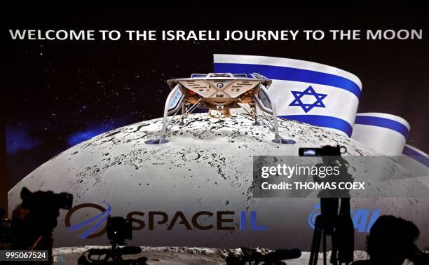 Journalists prepare to attend a press conference by Israeli Aerospace Industries space division to announce the launch of an spacecraft to the moon...