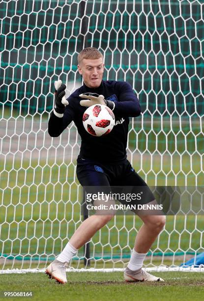 England's goalkeeper Jordan Pickford prepares to make a save as he takes part in a training session in Repino on July 10, 2018 ahead of their...