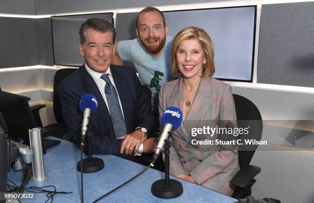 Pierce Brosnan and Christine Baranski pose with Tom Price at Magic Radio on July 10, 2018 in London, England.