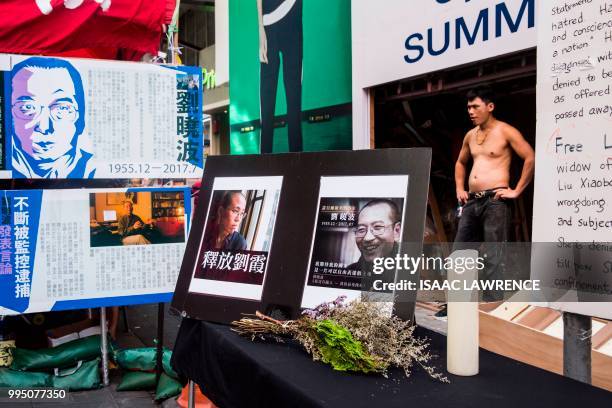 Picture of the late Chinese Nobel laureate Liu Xiaobo and his wife Liu Xia are displayed next to a booth in Hong Kong on July 10 after reports Liu...