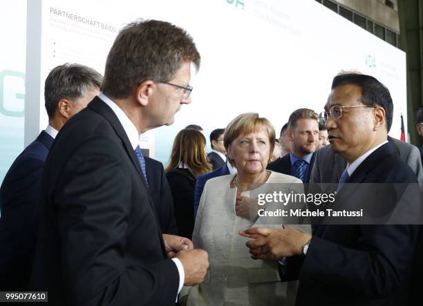 Klaus Froehlich manager at BMW and Harald Krueger BMW CEO explain the Automotive technology to German Chancellor Angela Merkel and Chinese Premier Li...