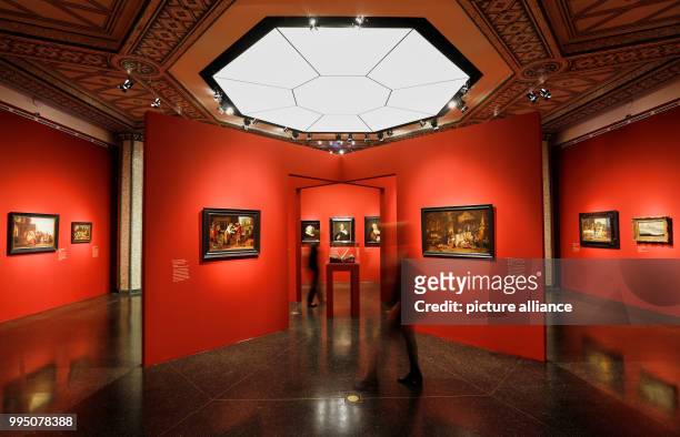 Two women walking through the exhibition "The Birth of the Art Market. Rembrandt, Ruisdael, van Goyen and the Artists of the Dutch Golden Age" in...