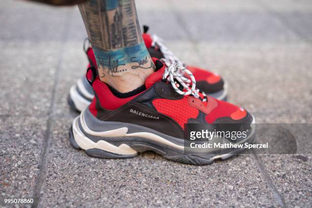 Chris Lavish, Balenciaga trainer detail, is seen on the street attending Men's New York Fashion Week wearing Balenciaga sunglasses and shoes on July...