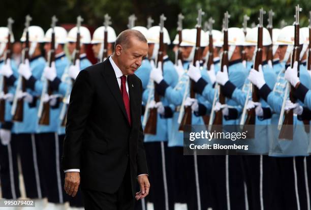 Recep Tayyip Erdogan, Turkey's president, inspects an honor guard after being sworn in under a new system of government at the Grand National...