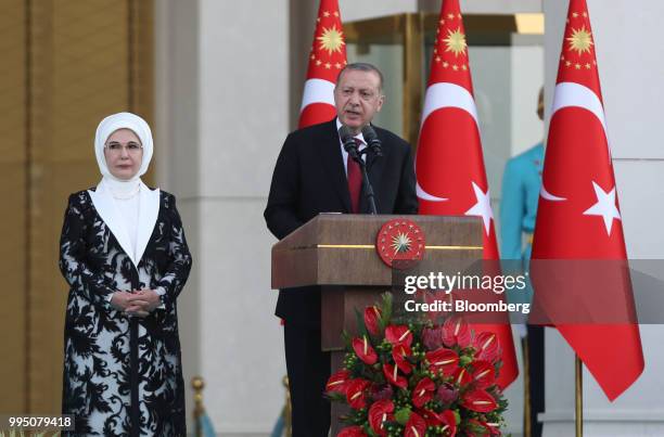 Recep Tayyip Erdogan, Turkey's president, speaks accompanied by his wife Emine Erdogan after being sworn in under a new system of government at the...