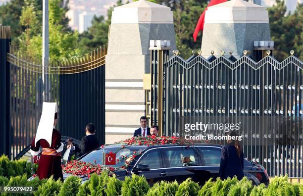Recep Tayyip Erdogan, Turkey's president, arrives for his swearing in ceremony in an automobile covered with flowers at the Presidential palace in...