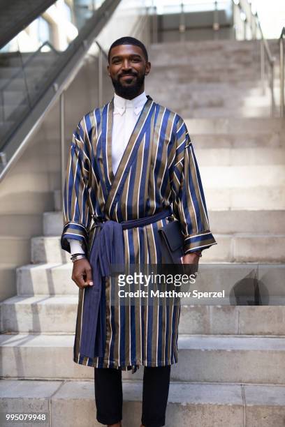 Guest is seen on the street attending Men's New York Fashion Week wearing a vintage kimono with COS and an Acetate bag on July 9, 2018 in New York...