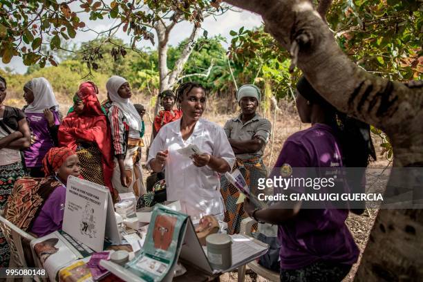 Mozambican nurse explains contraception methods and sexual education during an health point gathering organised by the United Nations Fund for...