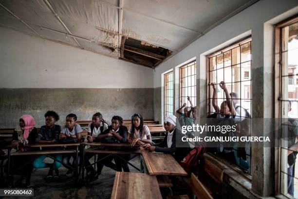 Mozambican girls listen to a contraception methods and sexual education briefing during a briefing at a public school organised by the United Nations...