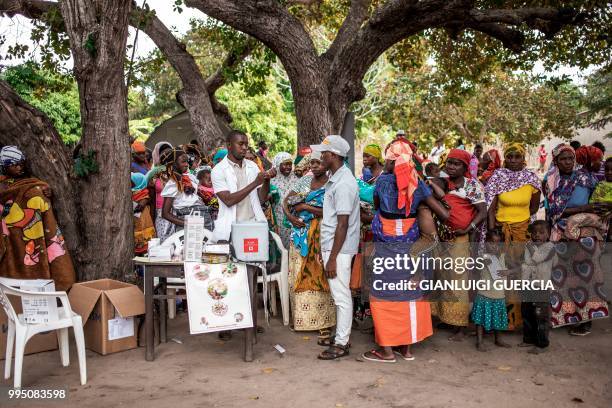 Mozambican nurse inoculates babies during an health point gathering organised by the United Nations Fund for Population activities in partnership...