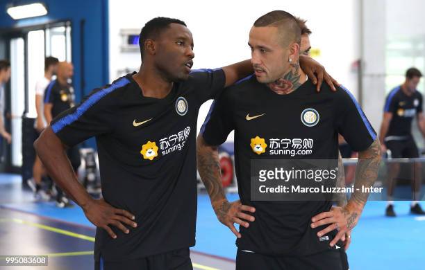 Kwadwo Asamoah embraces Radja Nainggolan of FC Internazionale during the FC Internazionale training session at the club's training ground Suning...