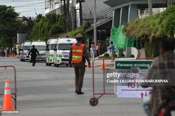 Ambulance vehicles are prepared for emergency evacuation outside the hospital in Chiang Rai where the boys rescued after being trapped in a Tham...