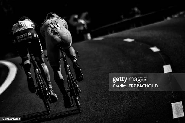 Slovakia's Peter Sagan, wearing the overall leader's yellow jersey and Germany's Marcus Burghardt ride during the third stage of the 105th edition of...