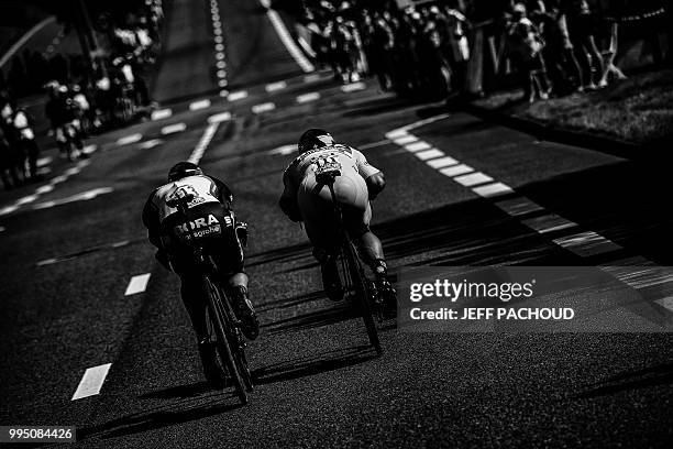 Slovakia's Peter Sagan, wearing the overall leader's yellow jersey and Germany's Marcus Burghardt ride during the third stage of the 105th edition of...