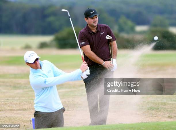 Patrick Reed of the United States watches his shot behind Nicolas Colsaerts of Belgium during practice for the Aberdeen Standard Investments Scottish...