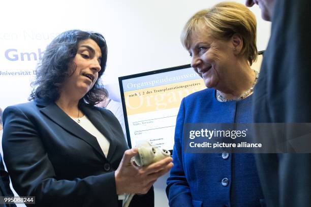 German Chancellor Angela Merkel speaking with heart surgeon Dilek Gursoy ahead of an election campaign event in Neuss, Germany, 21 September 2017....