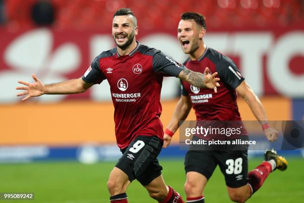 Nuremberg's Mikael Ishak celebrates after his goal for 3:1 goal with Eduard Loewen during the German 2nd Bundesliga football match between 1. FC...