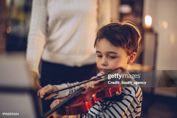 adorable little boy teaching to play violin - violin stock pictures, royalty-free photos & images