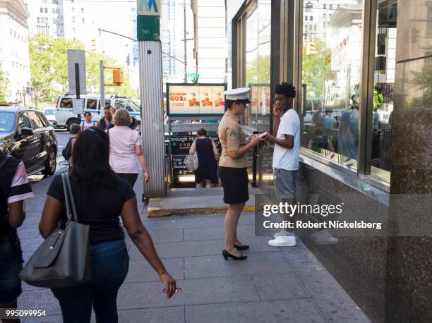 United States Marine Corps recruiter, second right, speaks to a young male July 5, 2018 in downtown Brooklyn, New York. The U.S. Military is facing a...