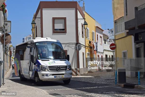 modern minibus driving on the street - fleet white vans stock pictures, royalty-free photos & images