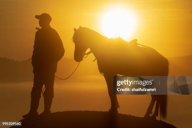 unidentified local people or bromo horseman at the mountainside of mount bromo, semeru, tengger national park, east java of indonesia. - shaifulzamri fotografías e imágenes de stock