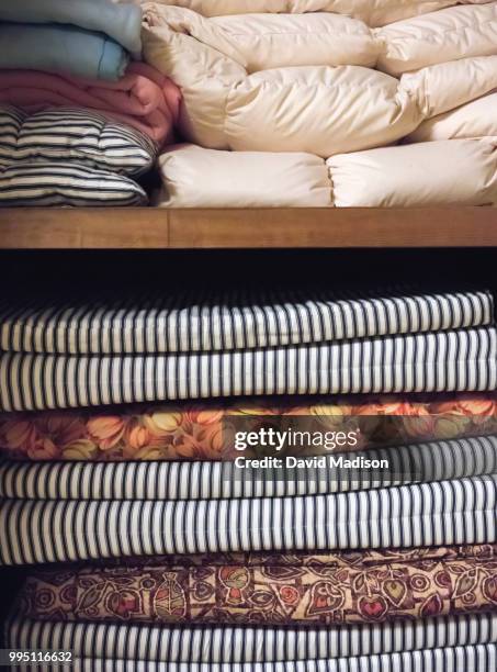 Futons and bedding stacked in cupboard in Japanese ryokan