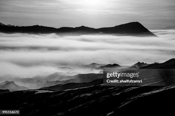 beautiful view landscape of active volcano crater with morning fog at mt. bromo, east java, indonesia. - shaifulzamri stock pictures, royalty-free photos & images