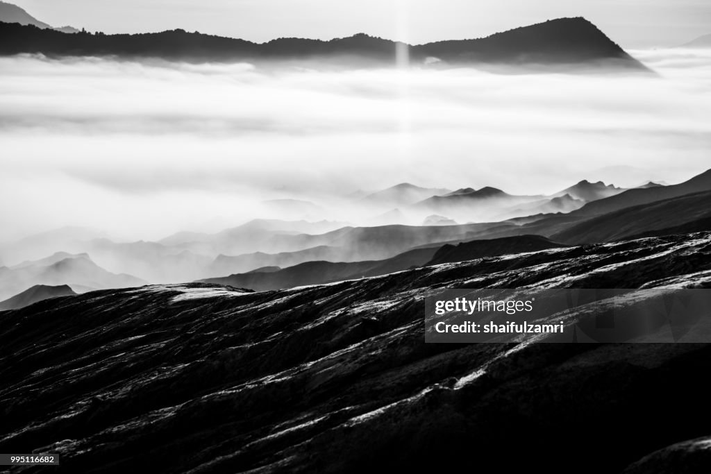 Beautiful view landscape of active volcano crater with morning fog at Mt. Bromo, East Java, Indonesia.