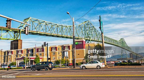 hotel under bridge in astoria oregon - astoria stock pictures, royalty-free photos & images