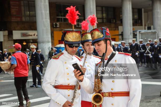 military marching band members checking cellphone - epaulet stock pictures, royalty-free photos & images