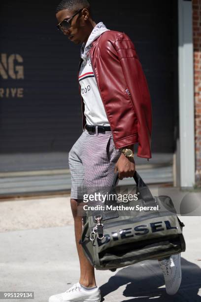Justiin Davis is seen on the street attending Men's New York Fashion Week wearing Zara with Dolce, Diesel, Michael Kors on July 9, 2018 in New York...