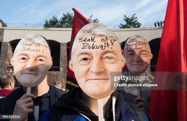 Employees of Thyssenkrupp wear masks of Heinrich Hiesinger, chairman of the management of Thyssenkrupp AG, during a protest organised by the worker's...