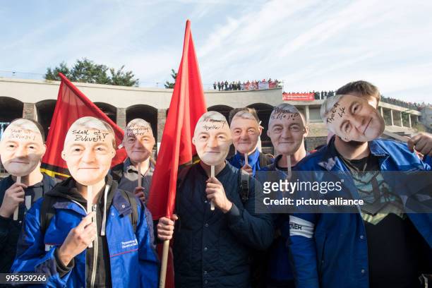 Employees of Thyssenkrupp wear masks of Heinrich Hiesinger, chairman of the management of Thyssenkrupp AG, during a protest organised by the worker's...