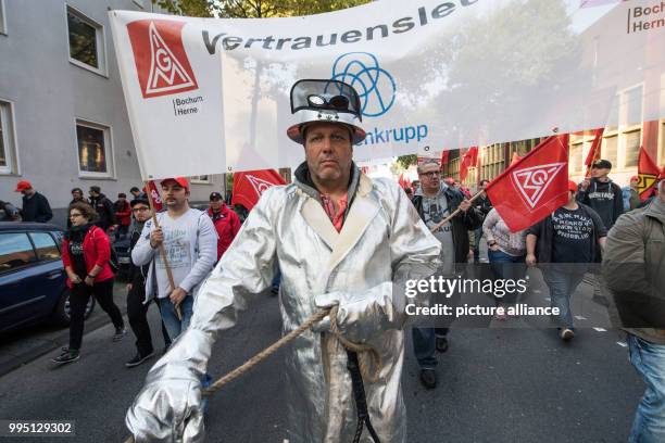 Demonstrator wears his protective clothing during a protest organised by the worker's council and the IG Metall union in Bochum, Germany, 22...