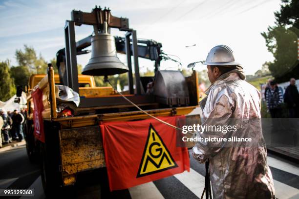 An employee wears his protective clothing during a protest organised by the worker's council and the IG Metall union in Bochum, Germany, 22 September...
