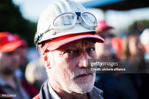 An employee of Thyssenkrupp participates in a protest organised by the worker's council and the IG Metall union in Bochum, Germany, 22 September...