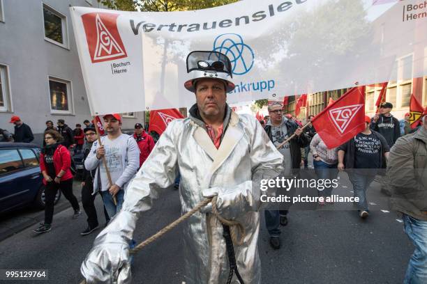 An employee wears his protective suit during a protest against the steel fusion plans of Thyssenkrupp with the Indian Tata group, organised by the...