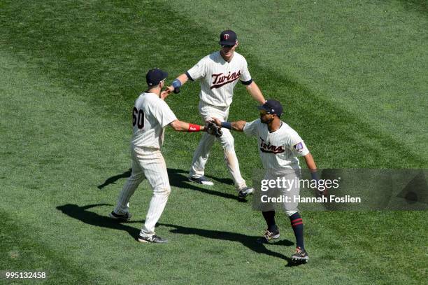 Jake Cave, Max Kepler and Eddie Rosario of the Minnesota Twins celebrate defeating the Baltimore Orioles after the game on July 7, 2018 at Target...