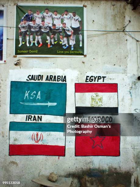 the street walls painted with flags of different countries - middle east flag stock pictures, royalty-free photos & images