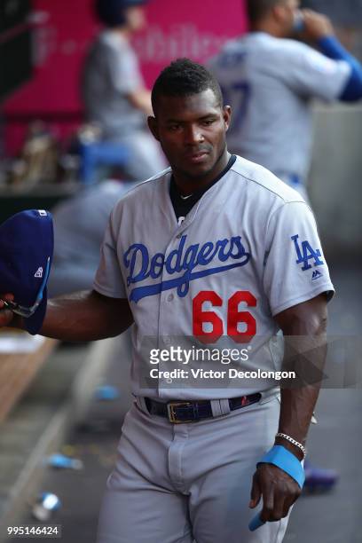 Yasiel Puig of the Los Angeles Dodgers looks on from the dugout prior to the MLB game against the Los Angeles Angels of Anaheim at Angel Stadium on...