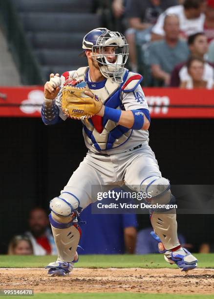 Catcher Yasmani Grandal of the Los Angeles Dodgers throws to second base in second inning during the MLB game at Angel Stadium on July 6, 2018 in...
