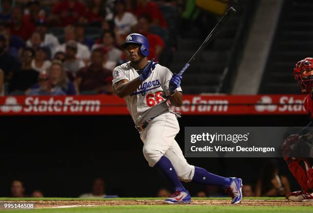 Yasiel Puig of the Los Angeles Dodgers bats during the fifth inning of the MLB game against the Los Angeles Angels of Anaheim at Angel Stadium on...