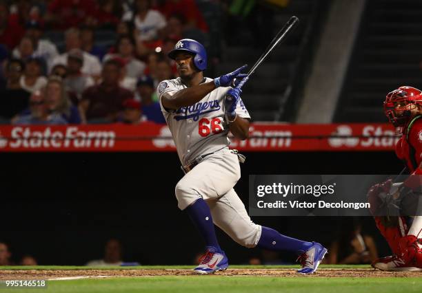 Yasiel Puig of the Los Angeles Dodgers bats during the fifth inning of the MLB game against the Los Angeles Angels of Anaheim at Angel Stadium on...